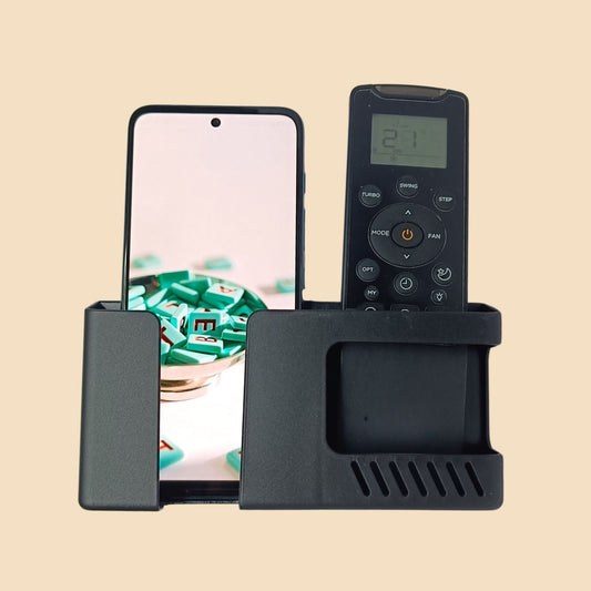 Wall-mounted mobile and remote holder with a smartphone in one pocket and an AC remote in the other